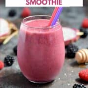 Dragon Fruit Smoothie in a glass surrounded by fresh berries with title graphic across the top.