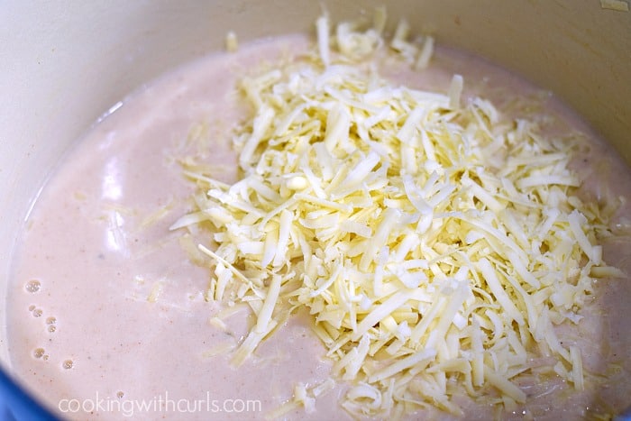 Grated cheese added to the thickened milk mixture.