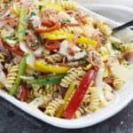 What is Antipasto Salad? Salami, pepperoni, roasted turkey, bell peppers, and rotini tossed in a light homemade Italian dressing for the perfect light lunch | cookingwithcurls.com