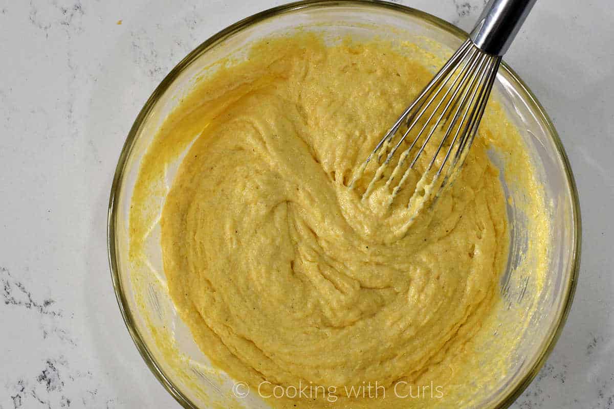 Cornbread batter mixed in a large mixing bowl.