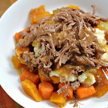 Simple Pot Roast with Carrots and Squash on a bed of mashed potatoes.