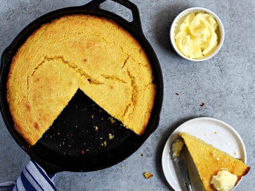 https://cookingwithcurls.com/wp-content/uploads/2016/10/Southern-Cornbread-recipe-in-a-cast-iron-skillet-with-bowls-of-butter-and-honey-in-the-background-cookingwithcurls.com_-500x375.jpg