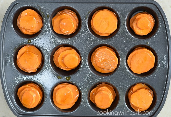 Stacks of sweet potato slices in a muffin pan.
