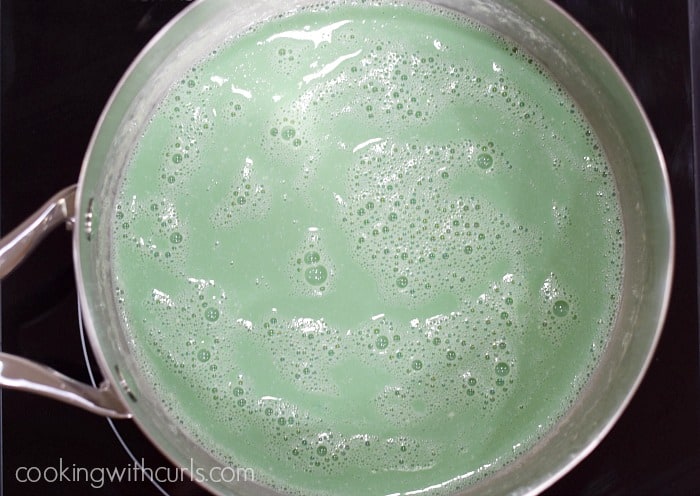 Green milk mixture in a saucepan.