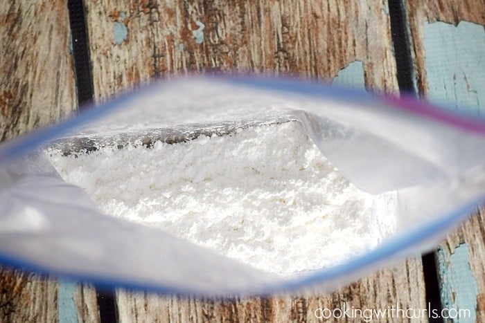 Looking into a zipper top bag containing powdered sugar.