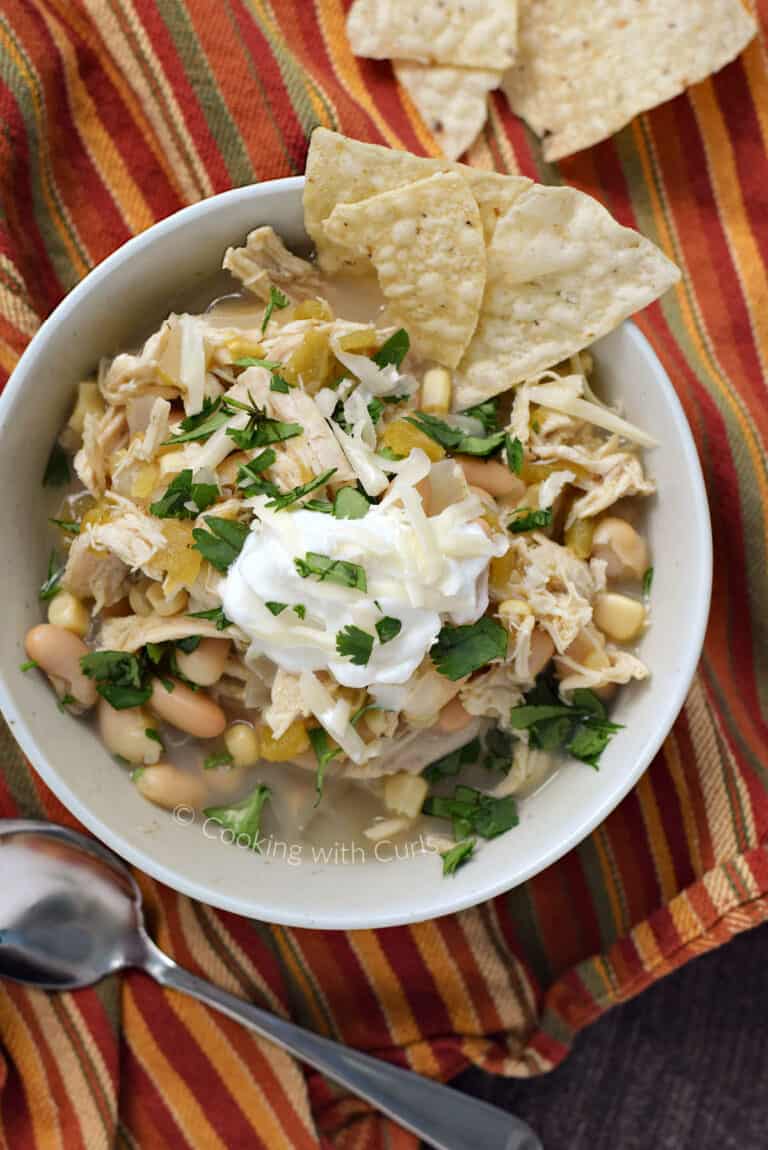 Slow Cooker White Chicken Chili Cooking With Curls   Looking Down On A Bowl Of White Bean Chili With Shredded Chicken Corn And Green Chilies Topped With Sour Cream Cilantro And Tortilla Chips. Cookingwithcurls.com  768x1150 