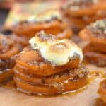 Stacks of sweet potato slices topped with pecans and toasted mini marshmallows
