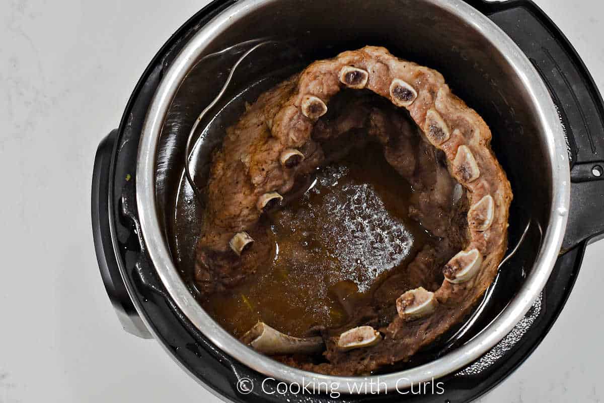 Cooked ribs inside a pressure cooker.