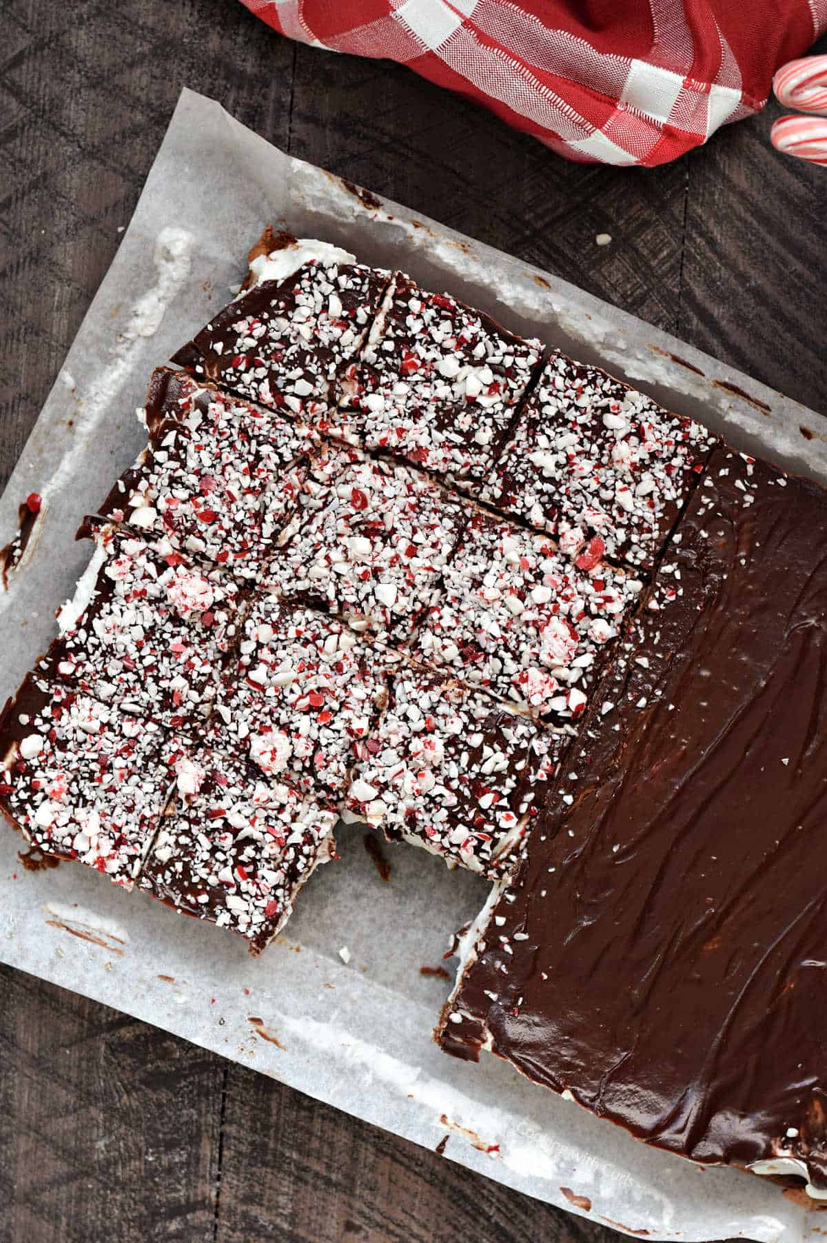 Fudgy peppermint brownies in parchment lined baking pan.