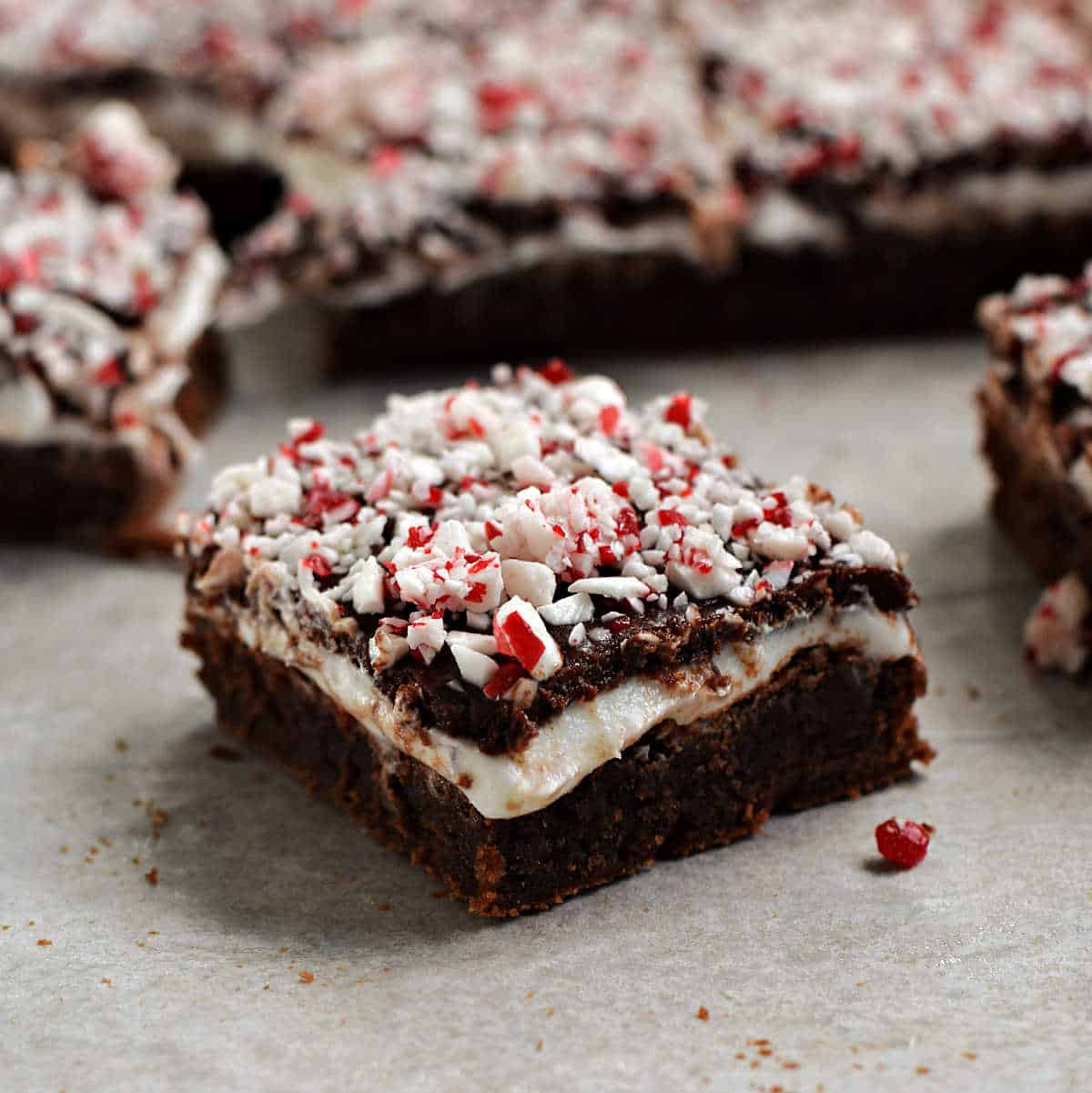 Fudgy brownies topped with creamy peppermint filling, chocolate ganache, and crushed candy canes.