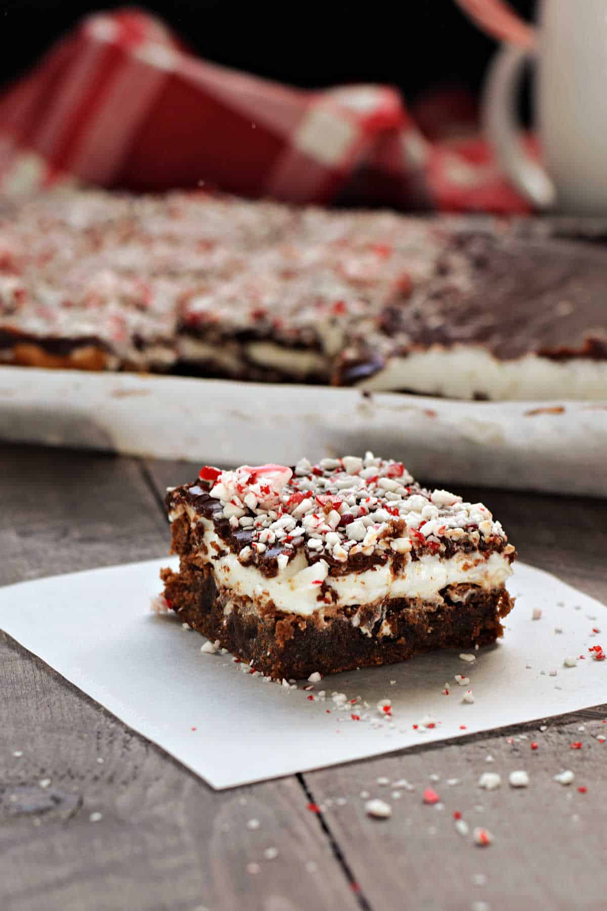 Fudgy brownies topped with creamy peppermint filling, chocolate ganache, and crushed candy canes.