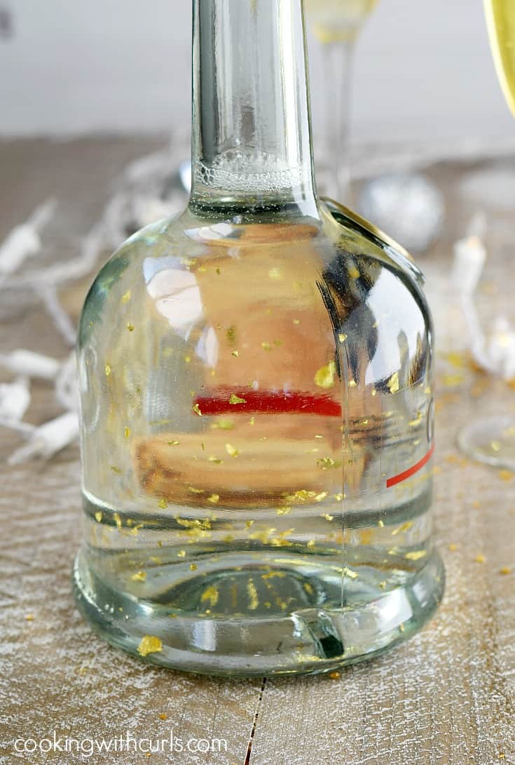 An image of a bottle of Goldschläger with gold flakes floating around inside.
