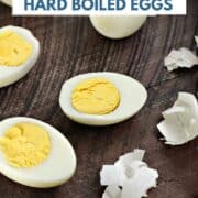 Two whole hard boiled eggs and two split in half surrounded by broken eggs shells with title graphic across the top.
