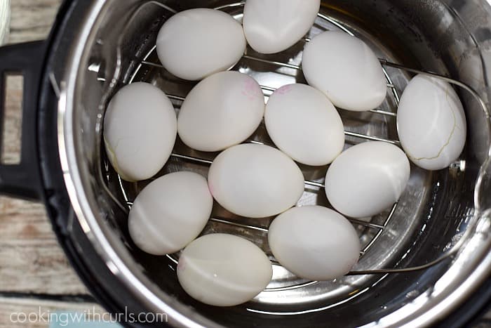 One dozen hard boiled eggs on a trivet in an Instant Pot.