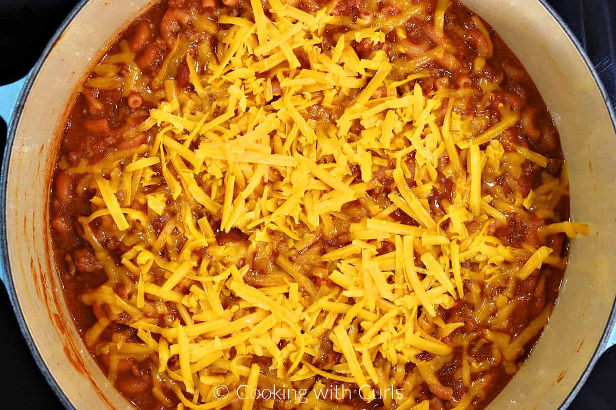 Shredded cheddar cheese on top of the chili mac.