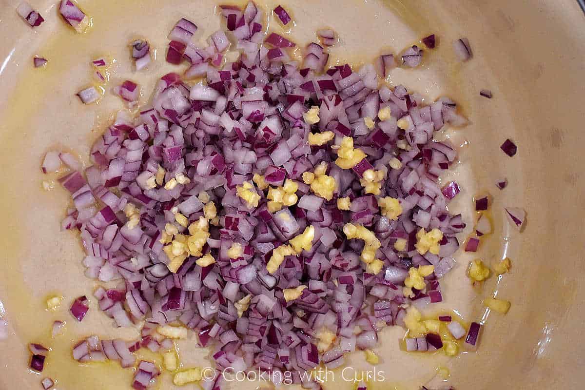Minced onion and garlic in a large pot.