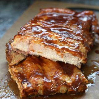 Instant Pot Barbecue Ribs stacked on top of each other on a cutting board