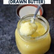 Clarified butter on a spoon resting on the edge of a jar with title graphic across the top.