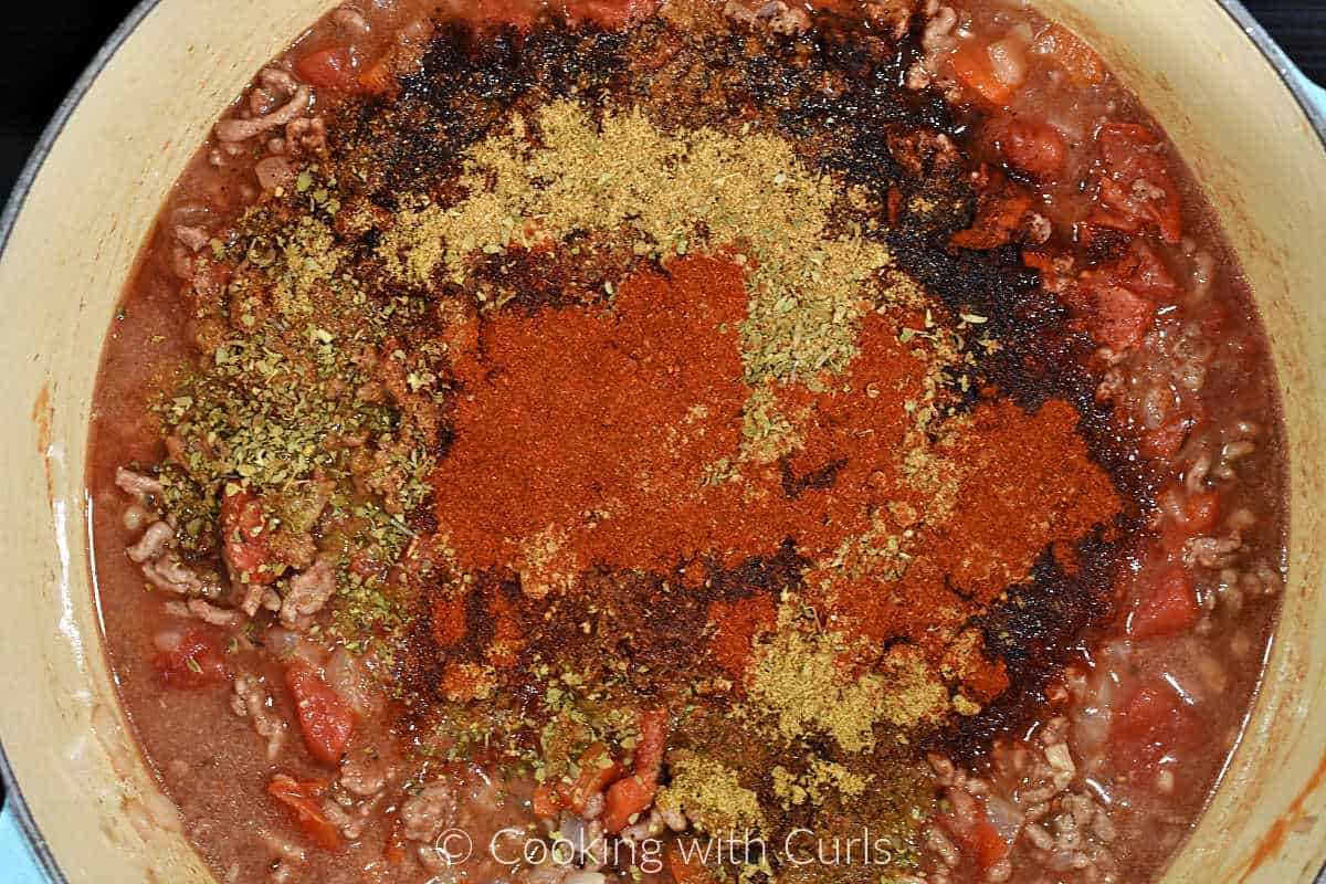 Tomatoes and seasoning added to the meat mixture.