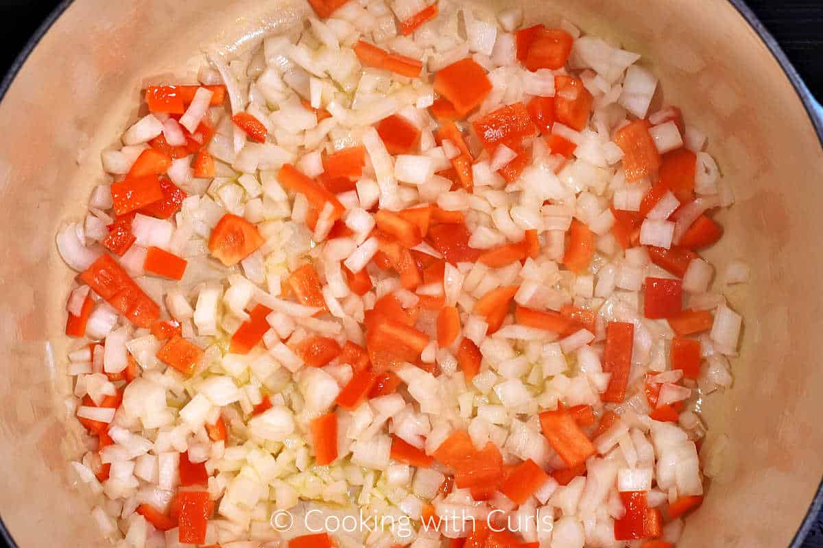 Diced onion, chopped red bell pepper, and oil in a large pot.
