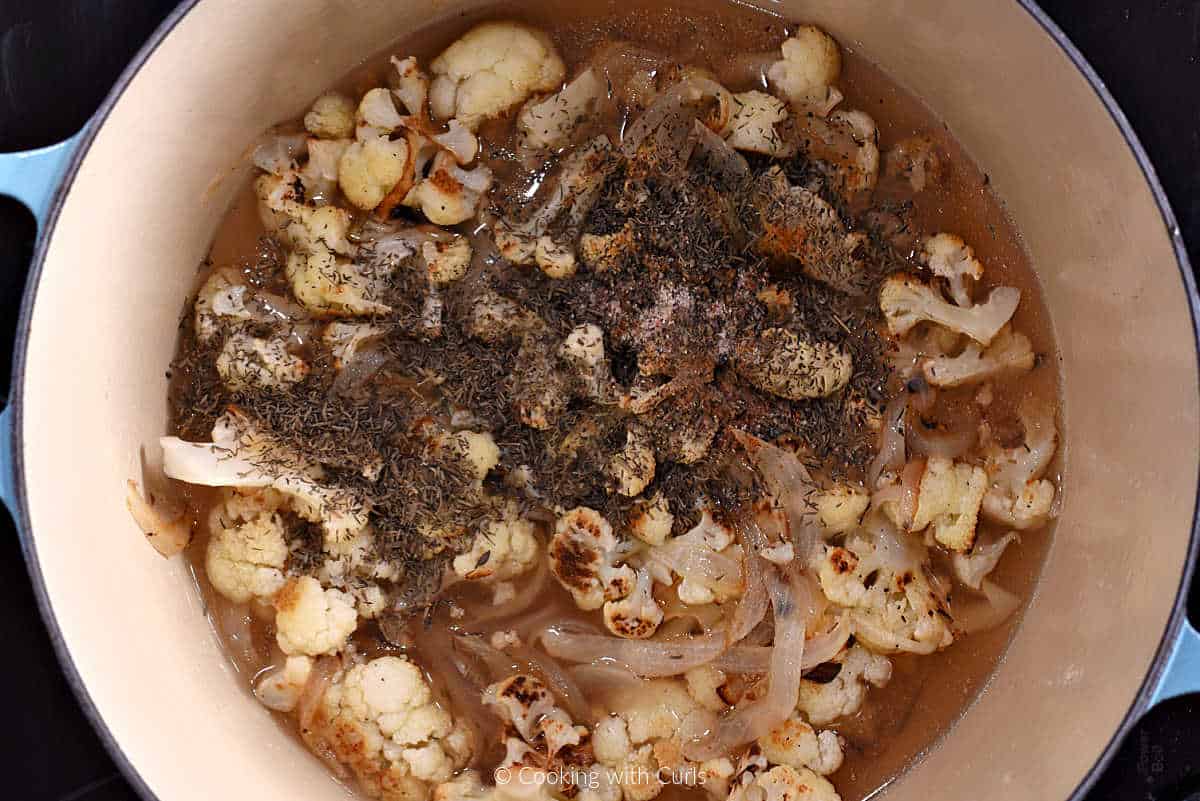 Roasted cauliflower, garlic, onion, broth, and thyme leaves in large pot.