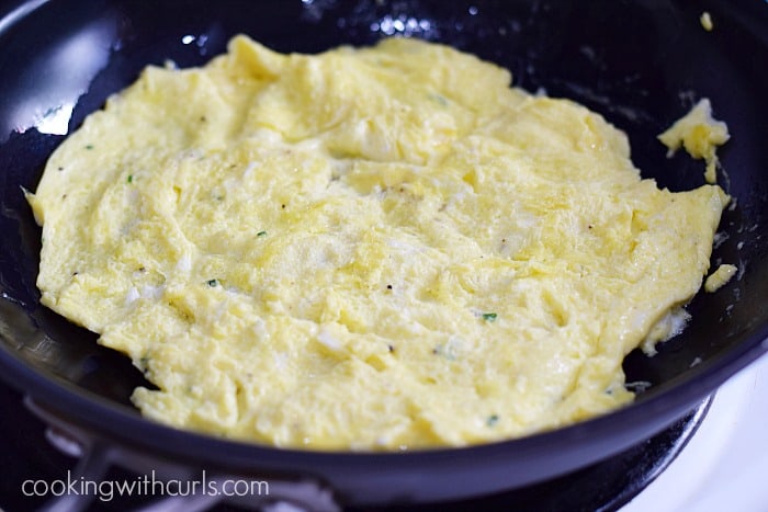 Scrambled eggs cooked into a flat "tortilla" in a non-stick skillet.