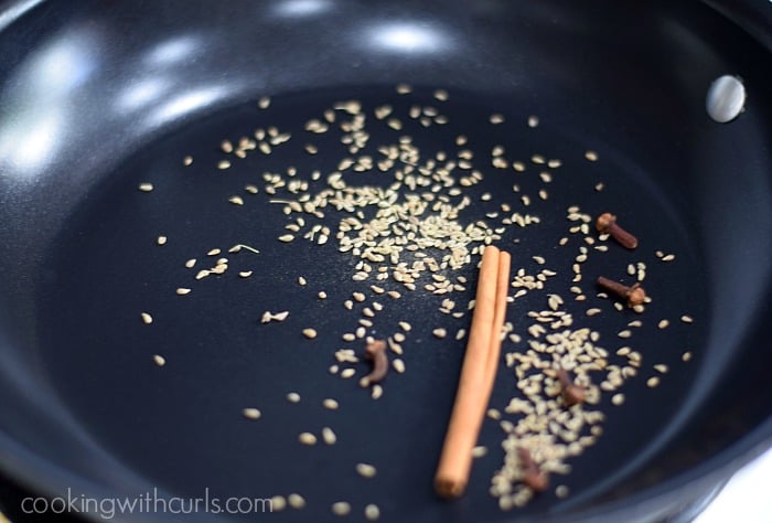 Corriander seeds, cinnamon stick. and cloves in a non-stick skillet.