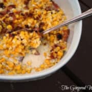 creamed corn with bacon in a casserole dish.