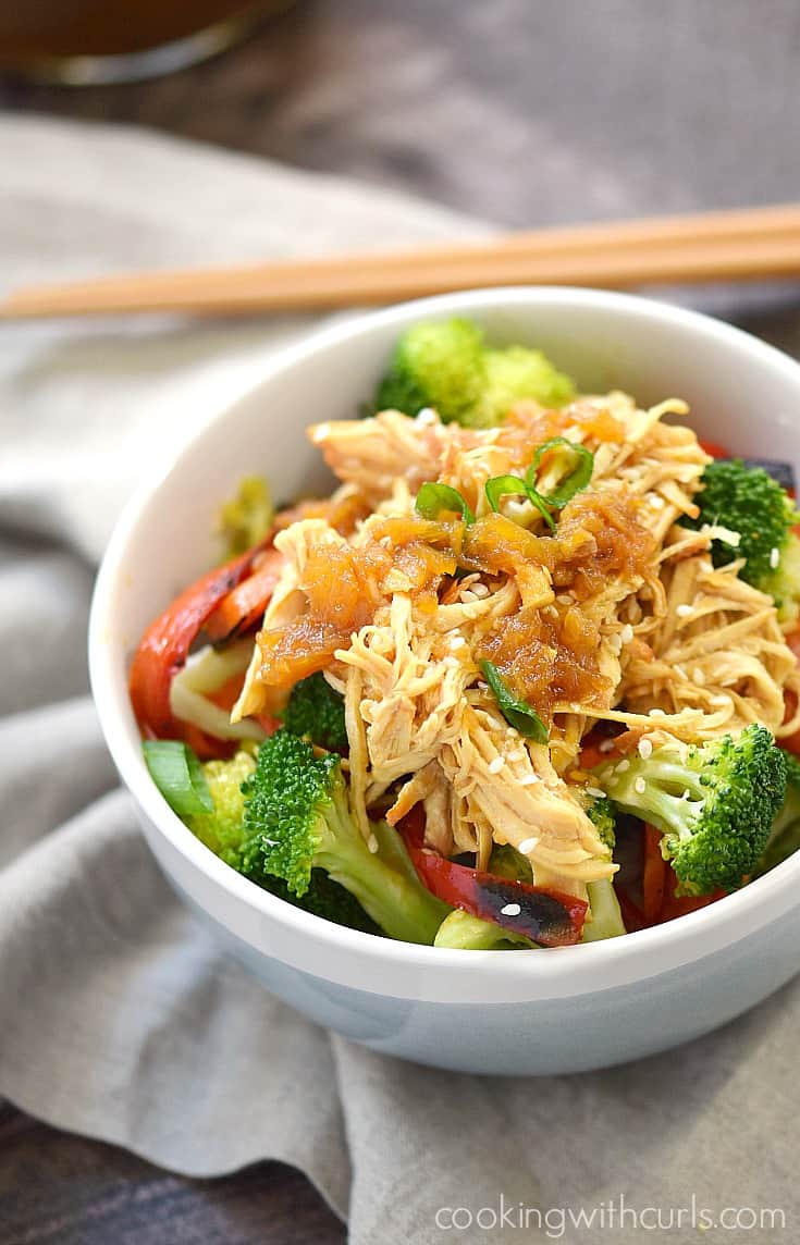 A bowl with Teriyaki Chicken mixed with broccoli, red peppers, and sesame seeds.