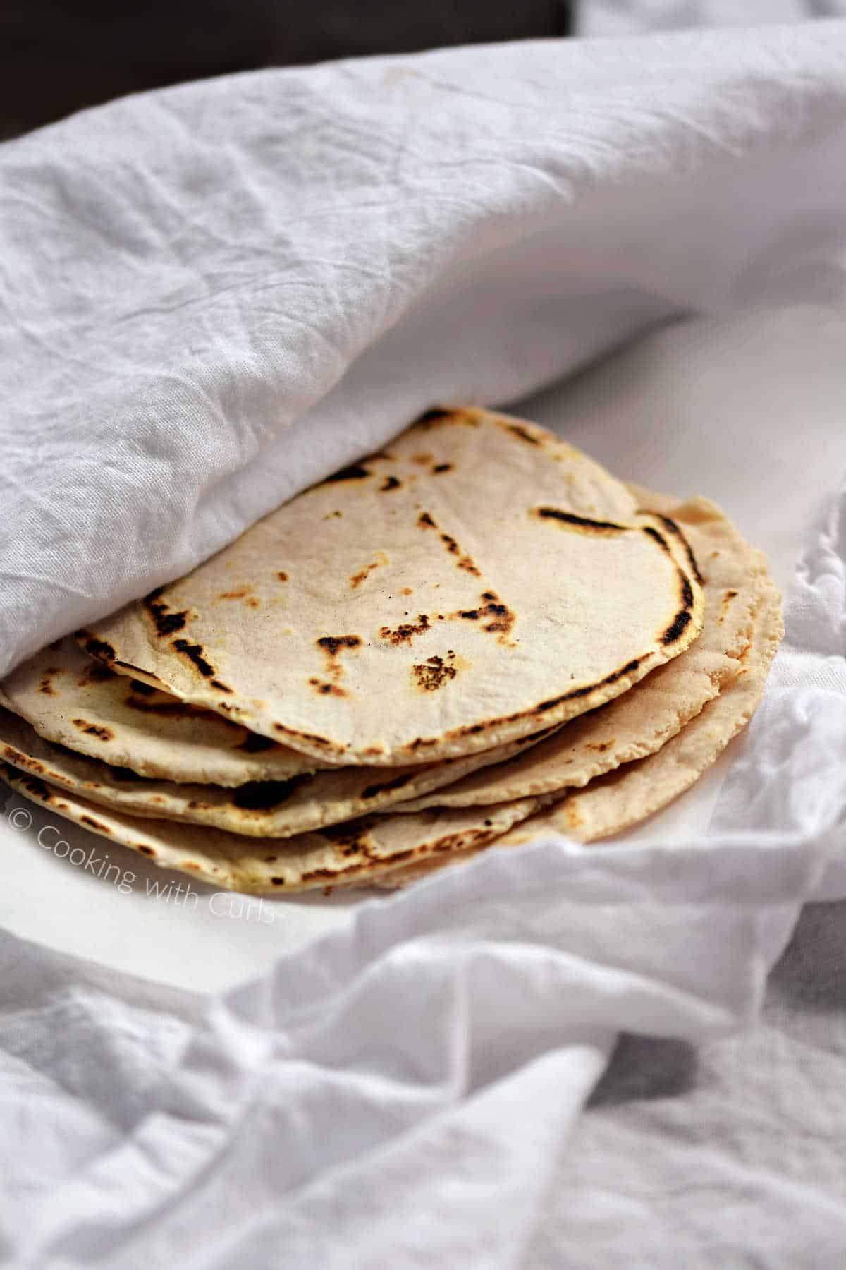 Six-cassava-flour-tortillas-stacked-on-a-white-towel.