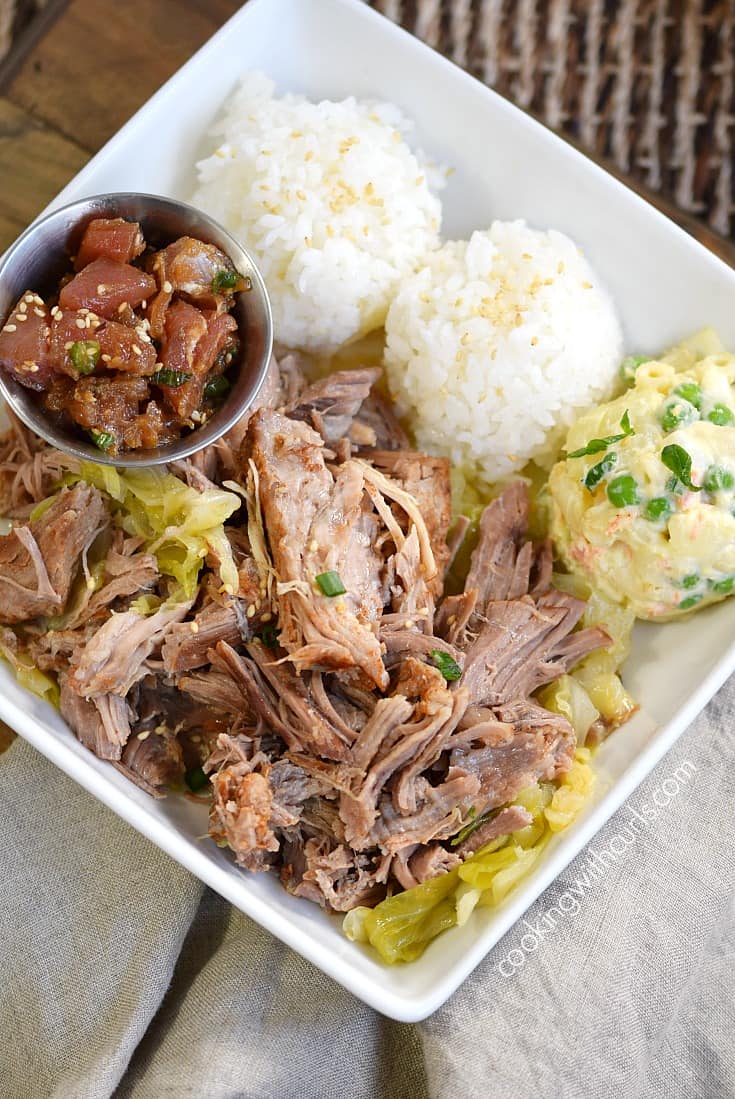 Instant Pot Kalua Pork bento lunch with sticky rice, Hawaiian potato salad and poke on a square plate.