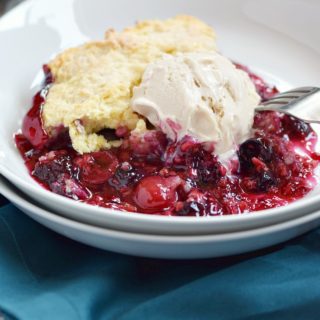 Very Berry Cobbler topped with vanilla ice cream | cookingwithcurls.com