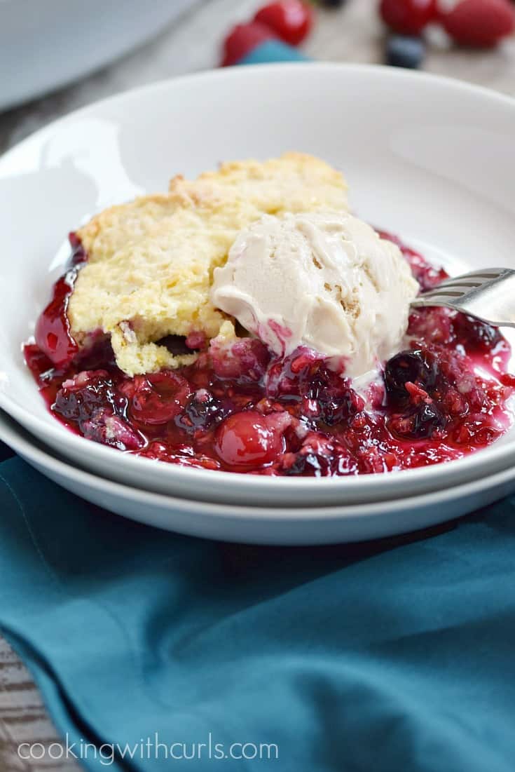 Very Berry Cobbler topped with vanilla ice cream | cookingwithcurls.com
