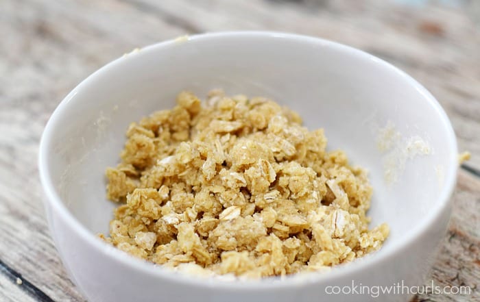 Oats, flour, brown sugar and pecan mixed together in a small bowl.