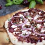 Cherry Bourbon Barbecue Pork Pizza will become a family favorite! Sweet and tangy sauce, salty shredded pork, and tangy Chevre make a winning combination cookingwithcurls.com
