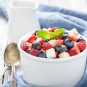 Red, white and blue chopped fruit salad in a bowl.