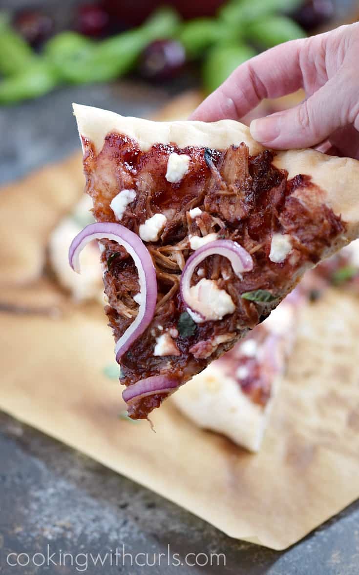 Grab a slice of this Cherry Bourbon Barbecue Pizza and be amazed at the flavors! Italian pizza dough topped with Cherry Bourbon Barbecue Sauce, leftover Kalua Pork, Chevre', thinly sliced onions, and fresh basil | cookingwithcurls.com