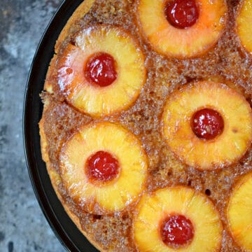 Skillet pineapple upside down cake served on a cake plate.