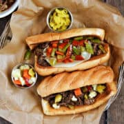 Two Instant Pot Italian beef sandwiches on a parchment lined basket.