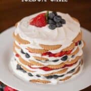 Icebox cake layered with wafer cookies, whipped cream, and fresh berries.