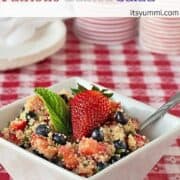 Quinoa and fresh fruit salad in a square bowl.