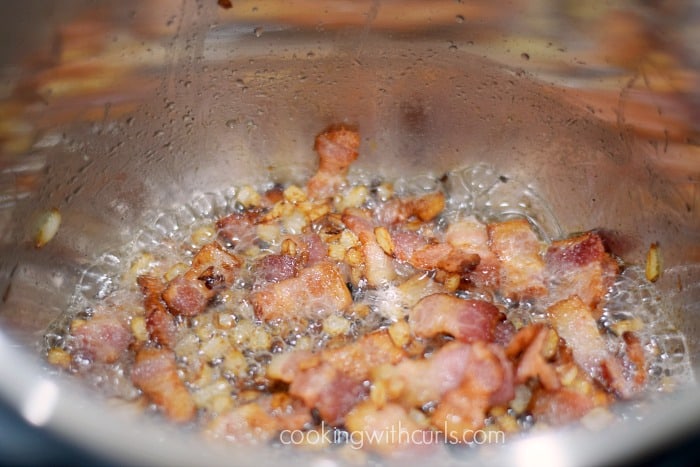 Bacon pieces cooking in an Instant Pot.