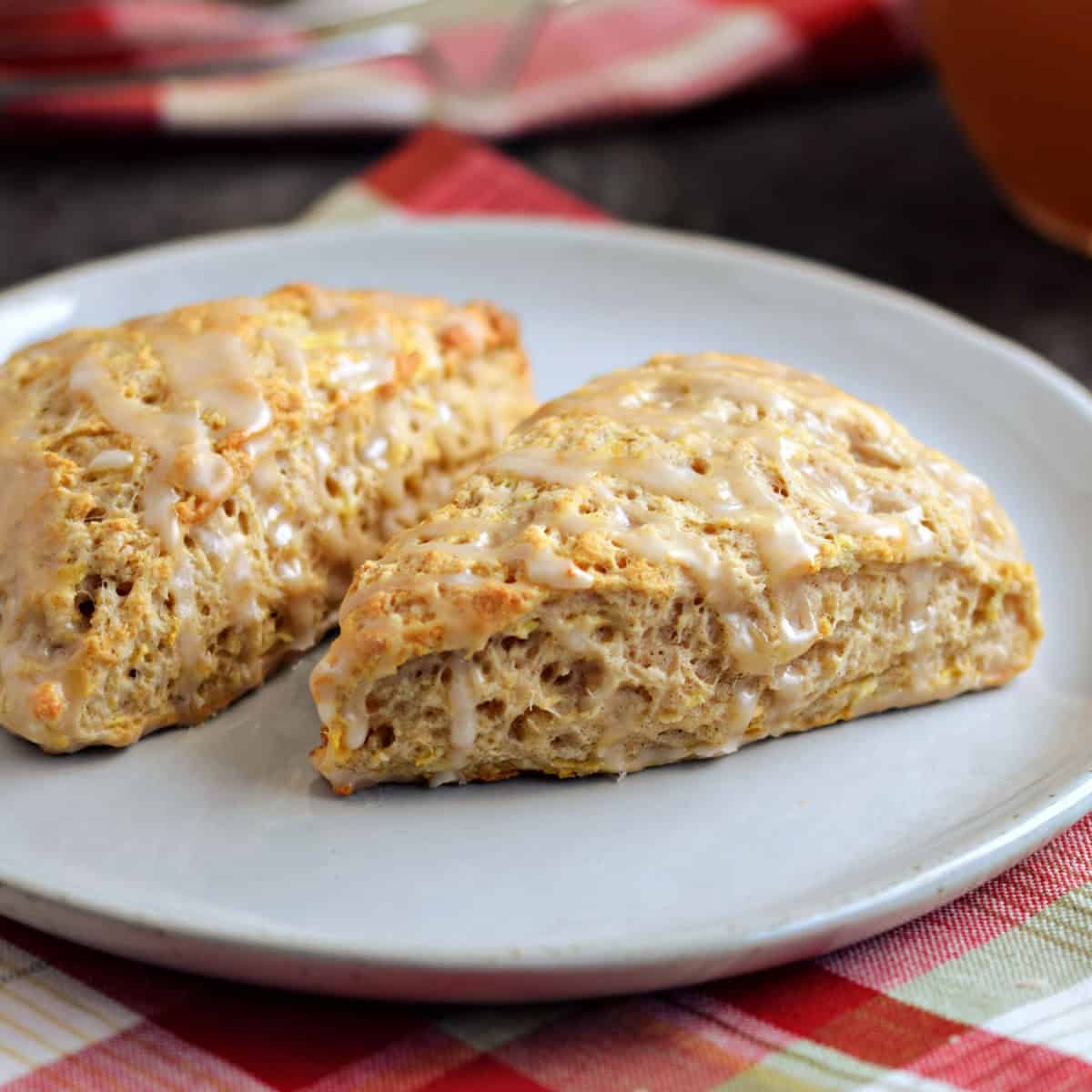 Two apple scones on a plate.