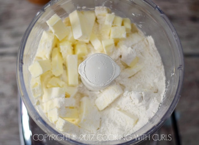 Pie Crust butter ingredients in the bowl of a food processor.