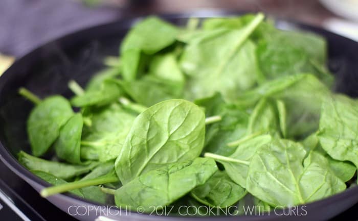 Fresh spinach in the skillet.