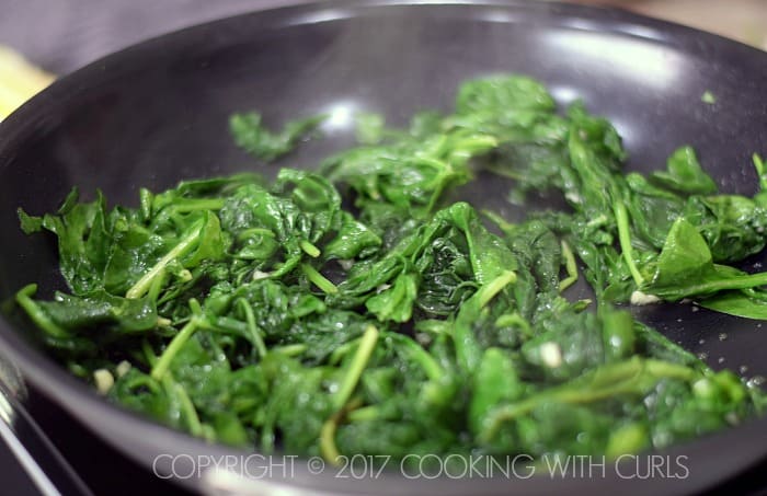Wilted spinach in a skillet.