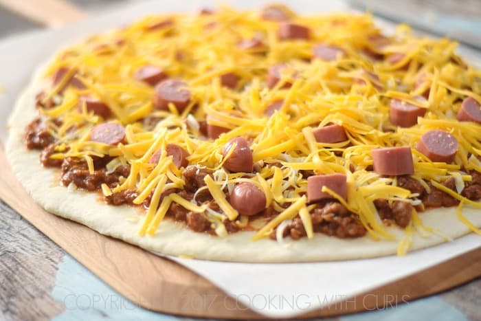 Chili Cheese Dog Pizza top with cheddar cheese COPYRIGHT © 2017 COOKING WITH CURLS