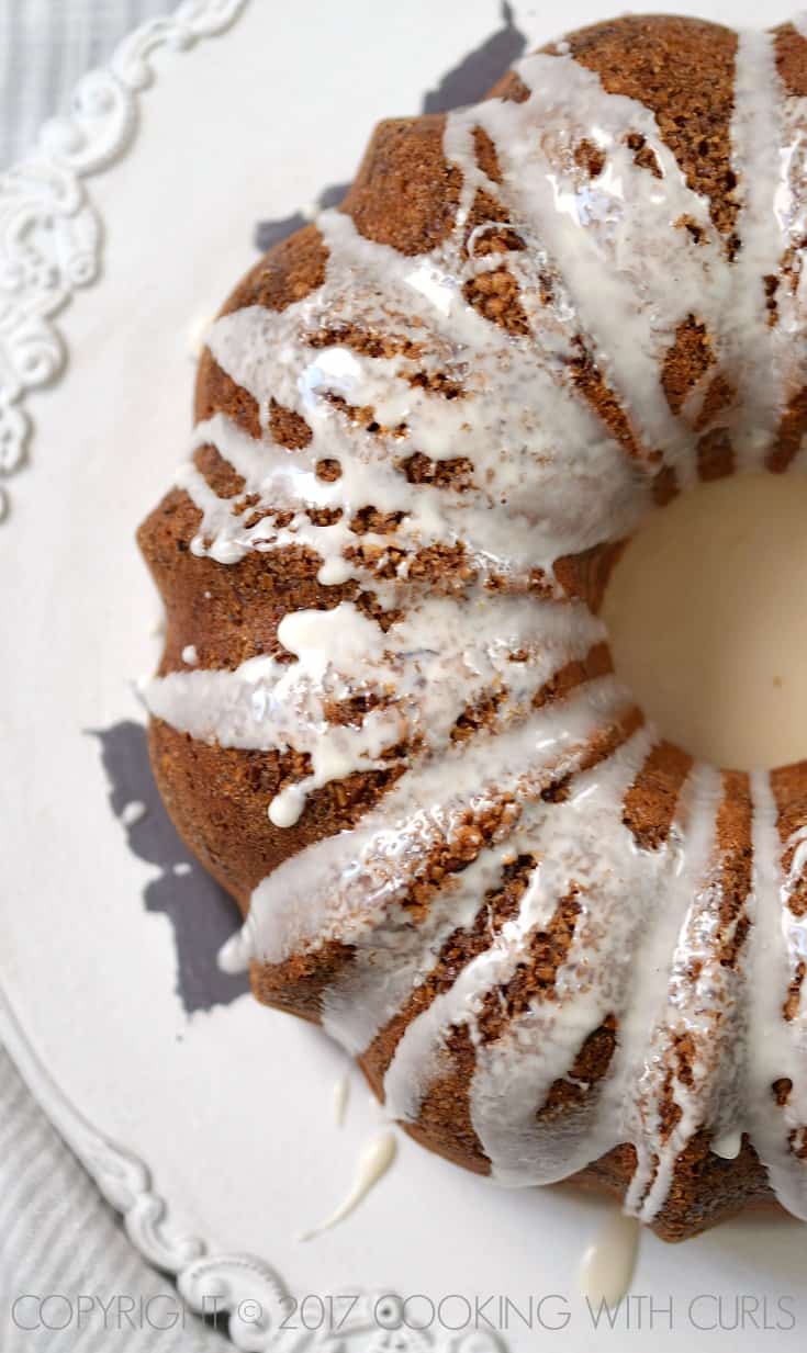 Looking down on a Cinnamon-Pecan Coffee Bundt Cake with glaze poured over the top.