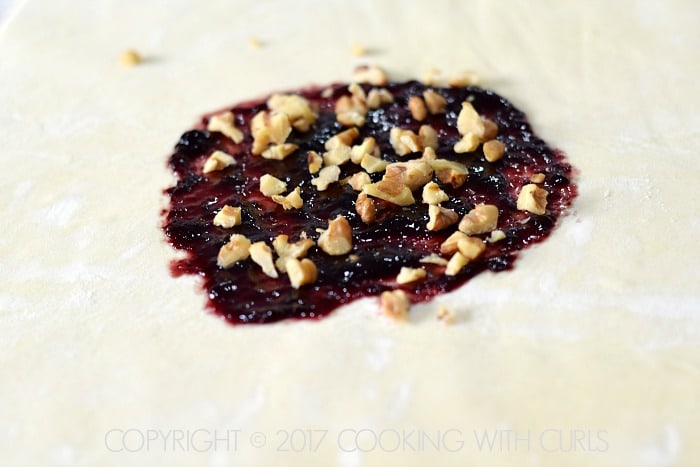 Blackberry jam and chopped walnuts in the center of a sheet of puff pastry.