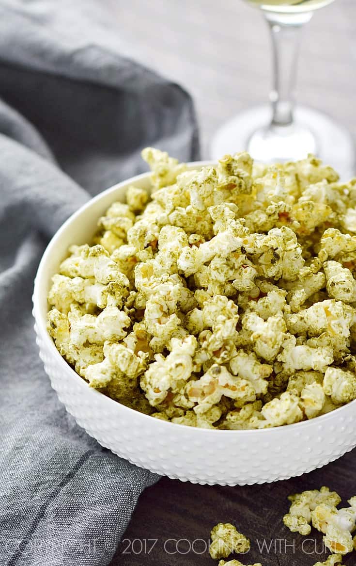 Green seasoned popcorn in a white bowl.